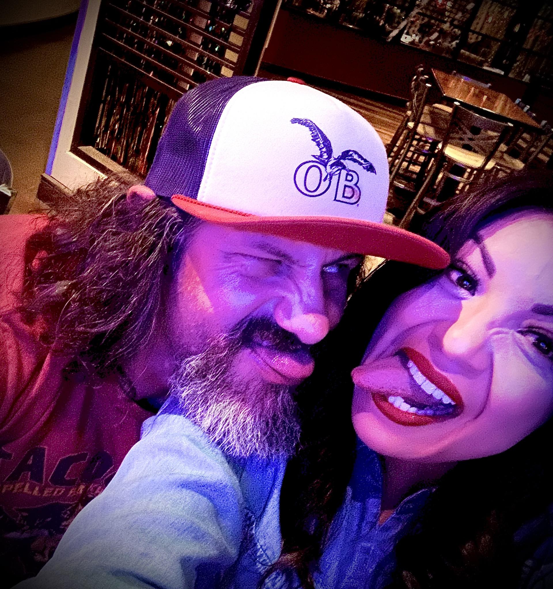Jimmy and Aimee laughing in colorful light