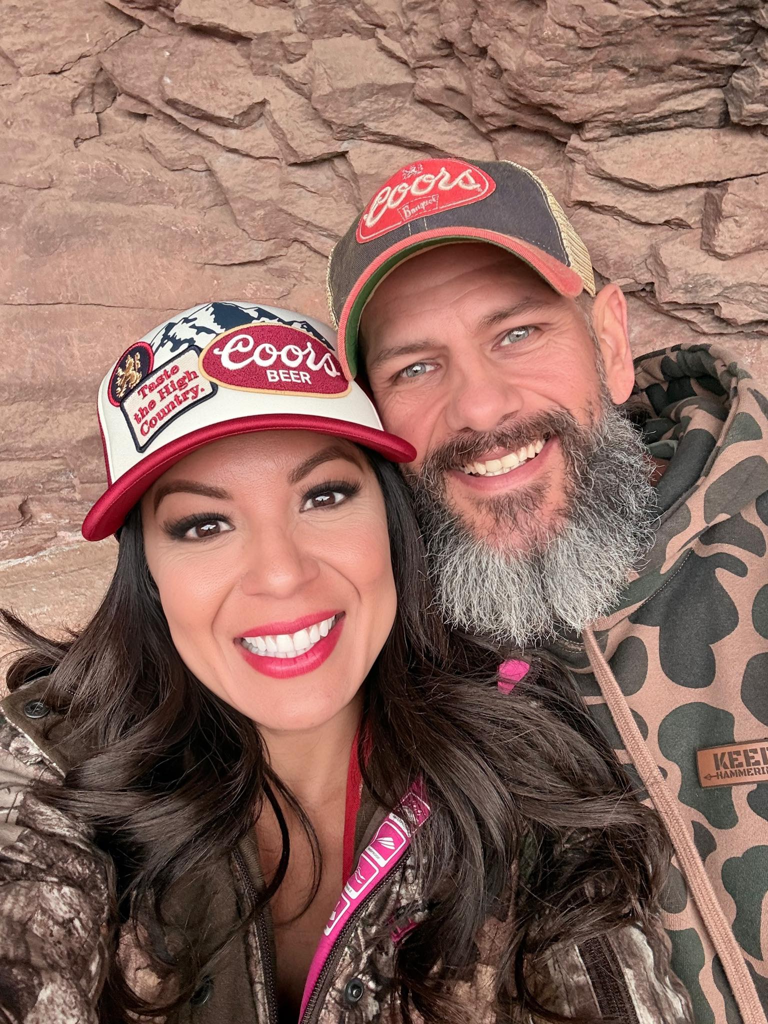 Jimmy and Aimee smiling together in outdoor hats